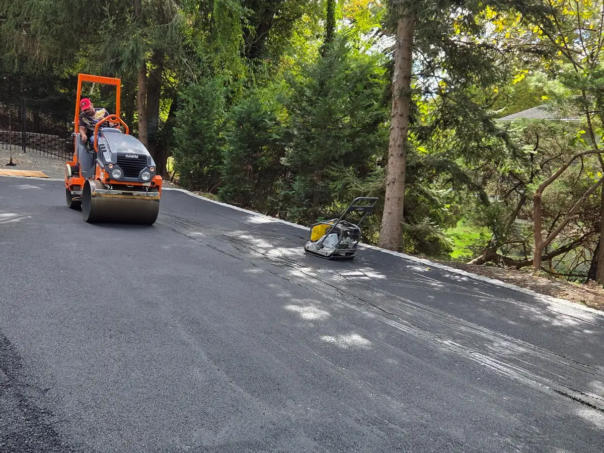 Roller paving an asphalt driveway. Work by Asphalt Direct Paving, Morris County, NJ.